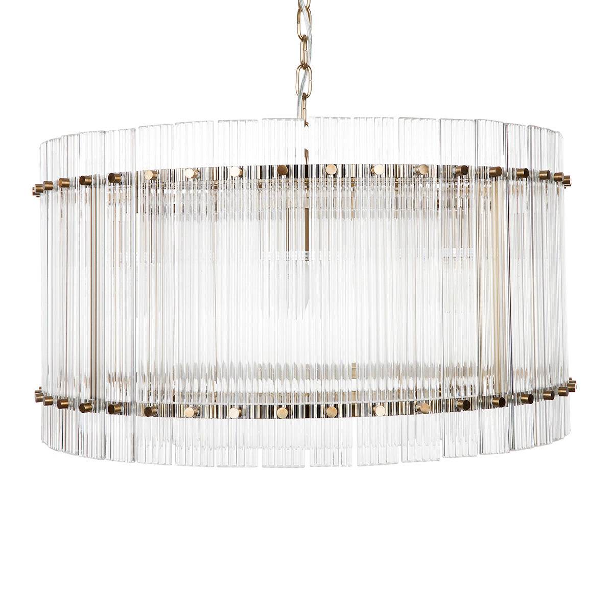 A round fluted glass pendant light with a brass frame and iron bulb fitting | Mirra Interiors