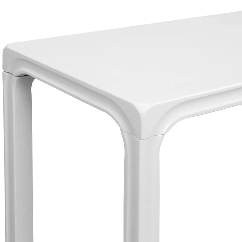 Close-up of a white minimalist console table with a plain background