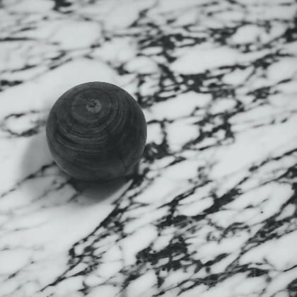 Wooden Black Styling Ball on white and black Marble Counter for Mirra Interiors