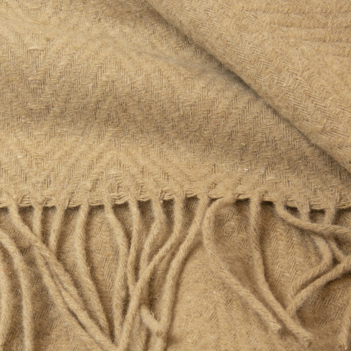Close-up of a camel fabric with fringes