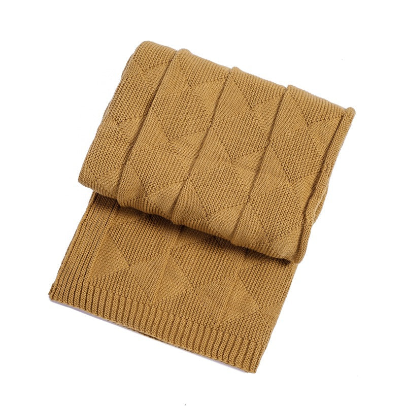 Folded khaki brown knitted blanket on a white background