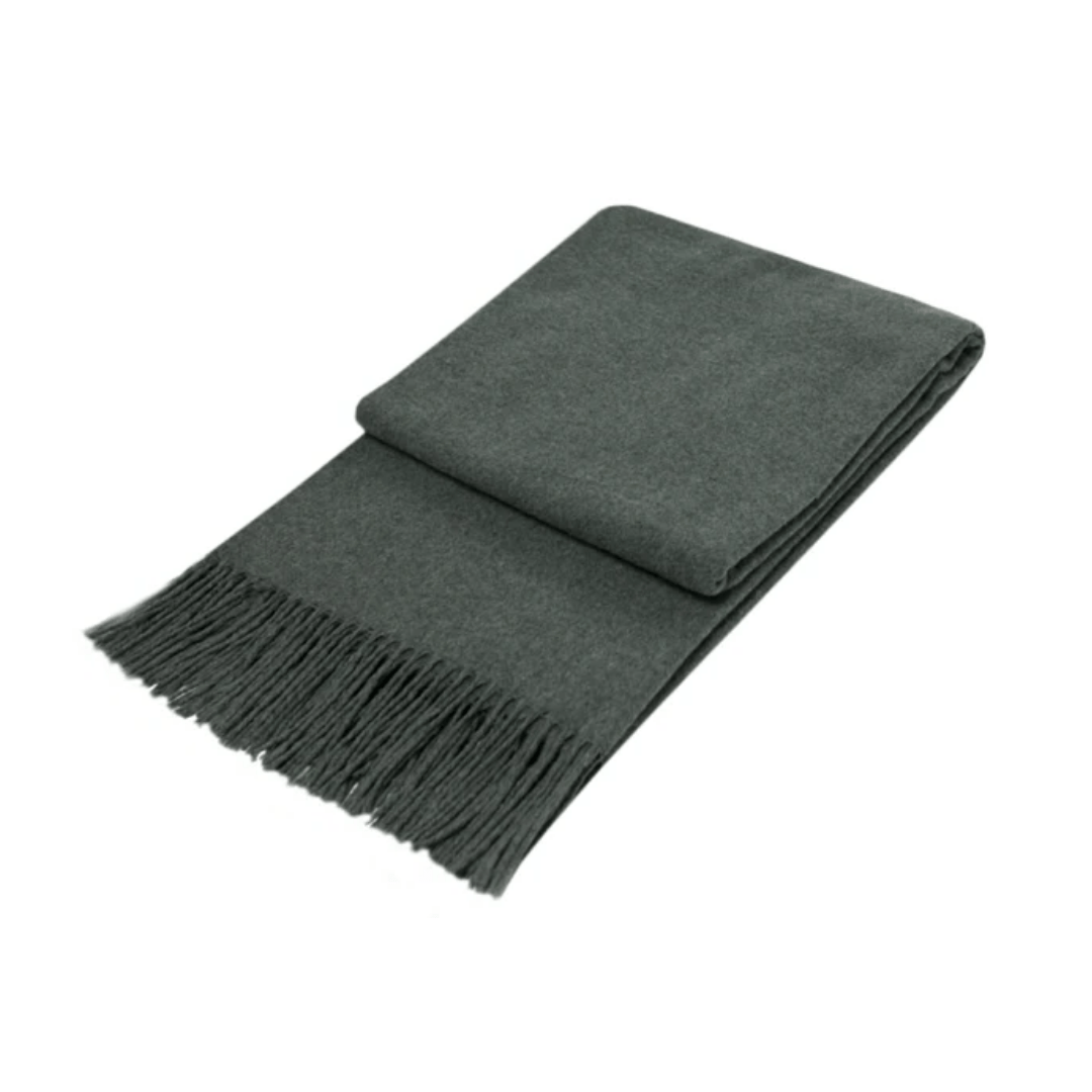 folded charcoal wool throw rug with fringe detail on white background