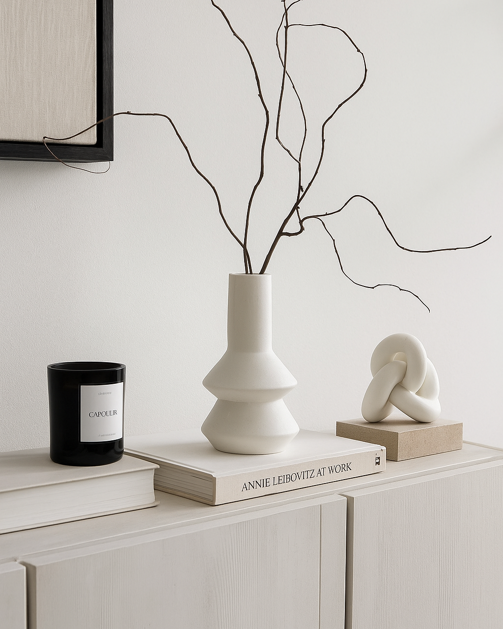 white geomatric vase with dried branches styled on a sideboard in a neutral setting | Mirra Interiors