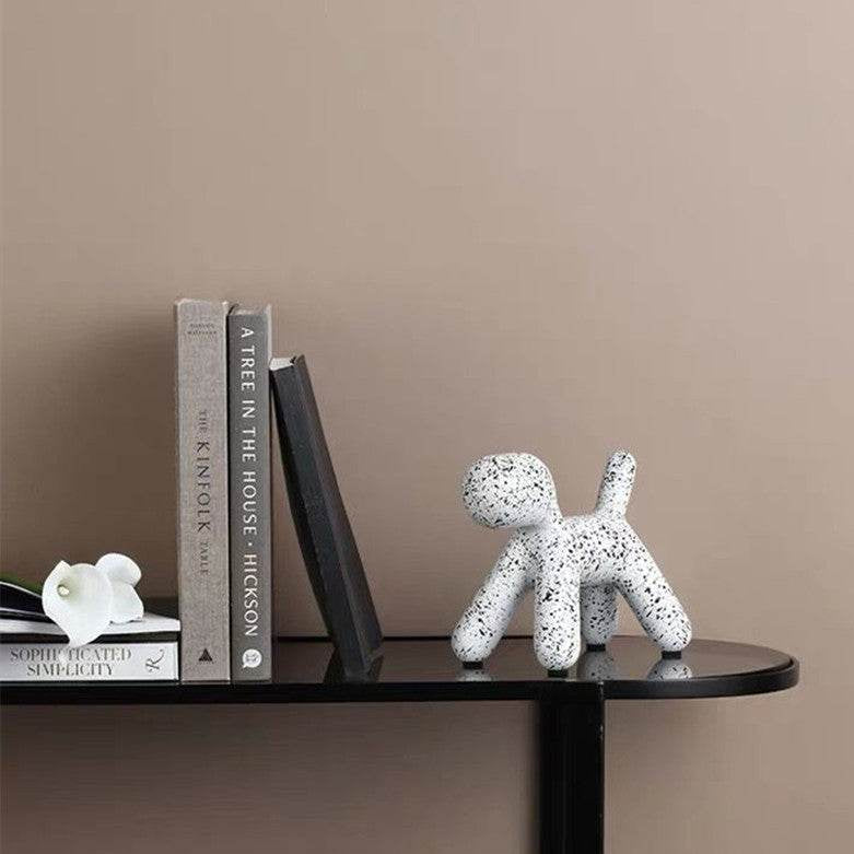 Toto Resin Dog Sculpture Dalmation Terrazzo Print Styled on black shelf with black and white books | Mirra Interiors