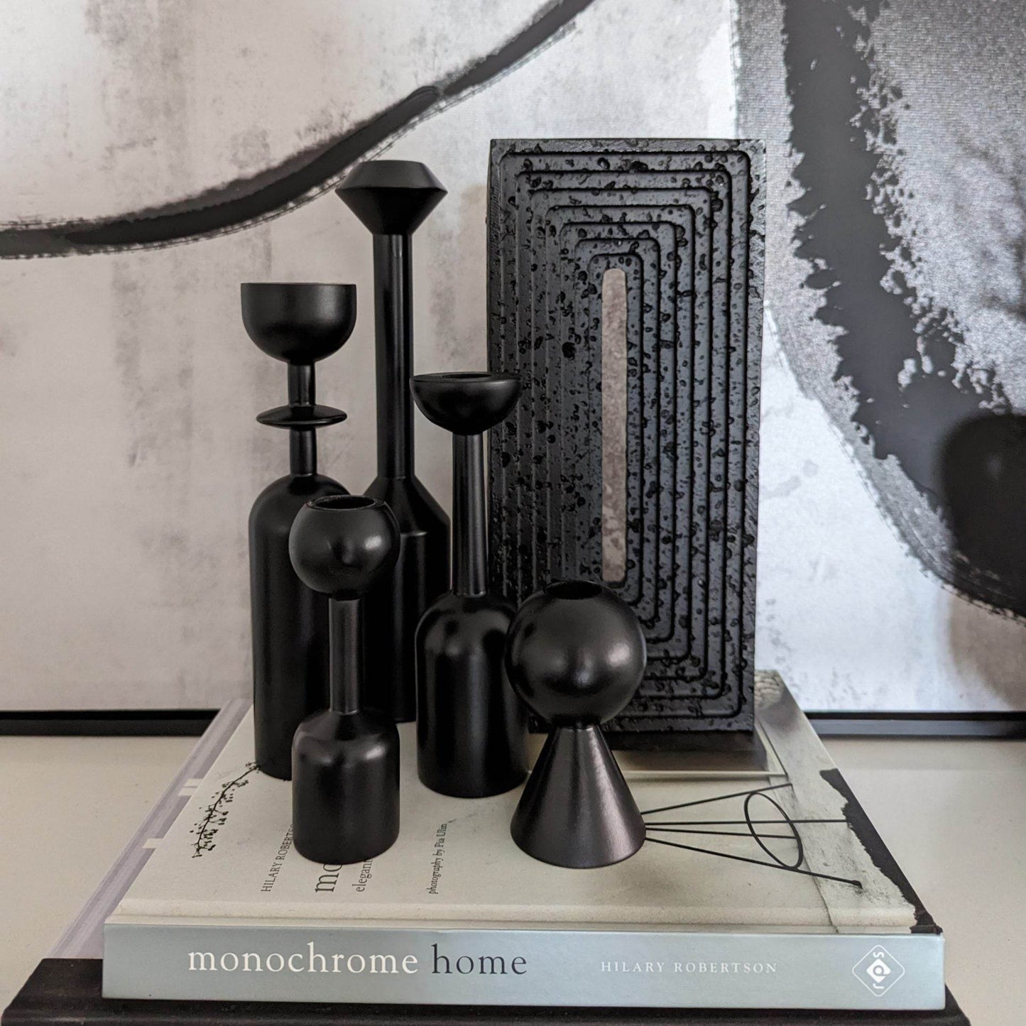 Black Resin Brick Sculpture styled on stack of books with black geometric candle set | Mirra Interiors