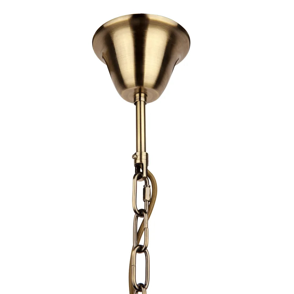 Gold pendant light fixture with chain on a white background