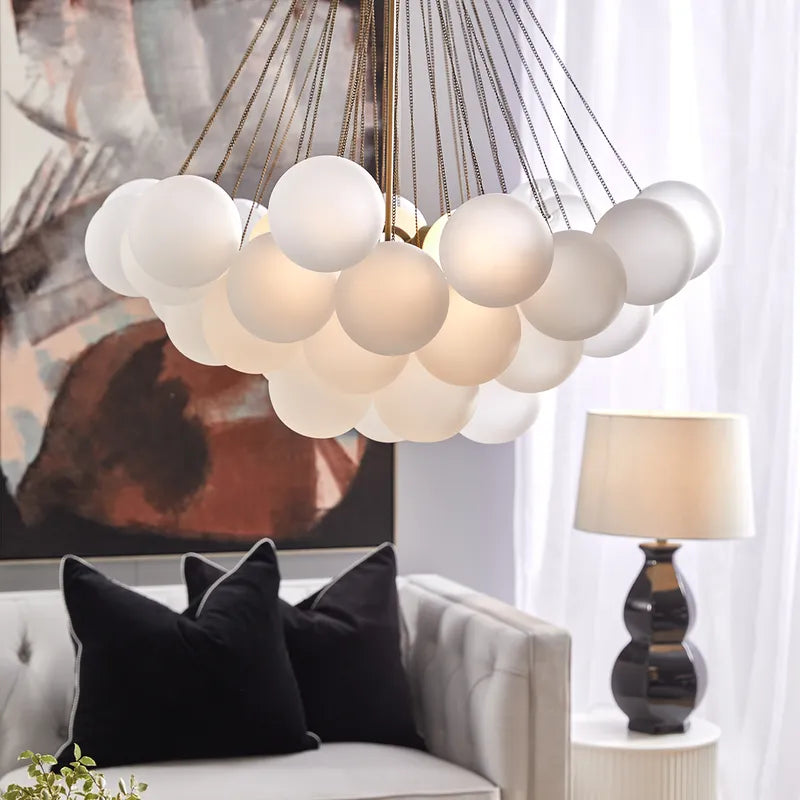 Modern chandelier with spherical lights in a living room setting Mirra Interiors