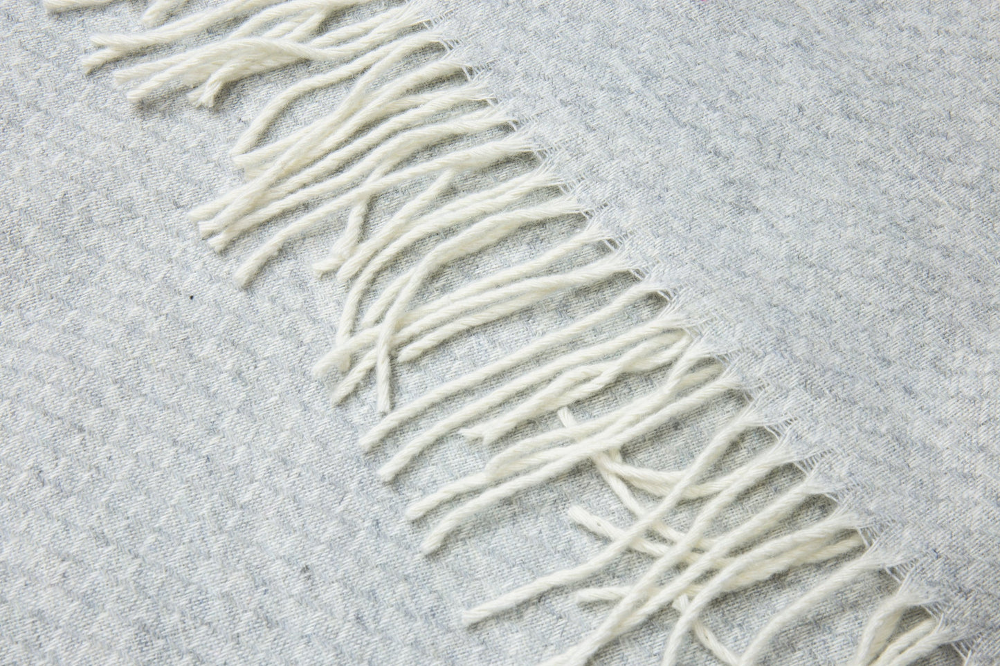light grey wool throw blanket rug close up