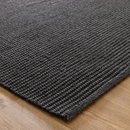 Black rug on a wooden floor