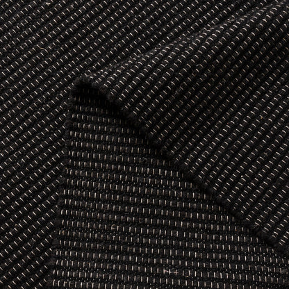 Close-up of black textured wool rug