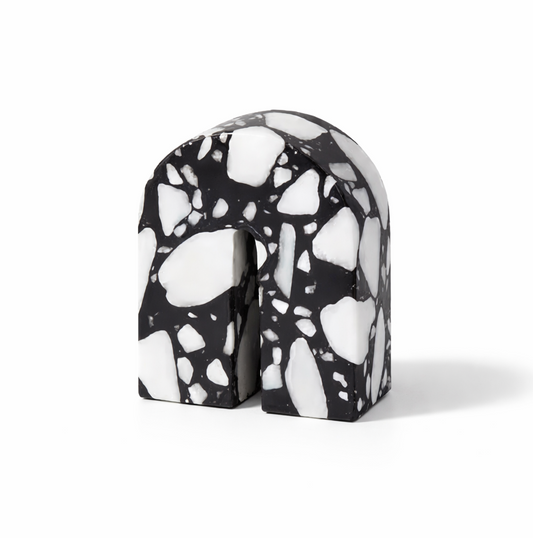 Black and white terrazzo-patterned object on a white background