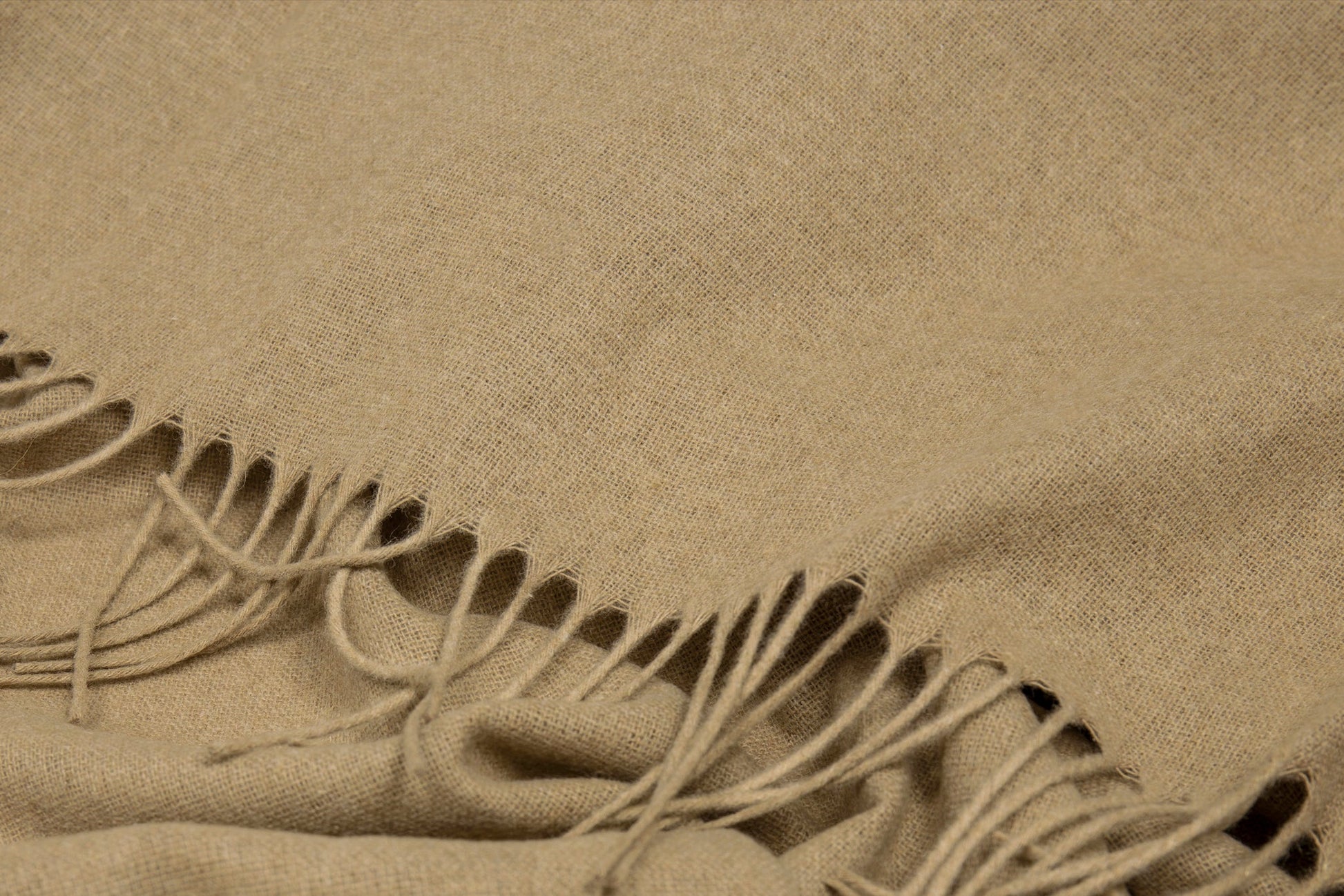 Beige fabric with fringes close up of texture