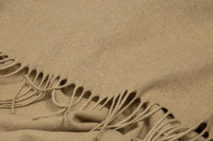 Beige fabric with fringes close up of texture