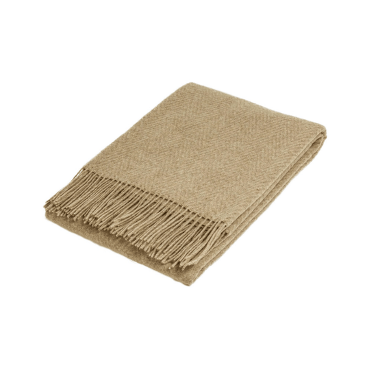 Folded camel wool throw rug with subtle self pattern on white background