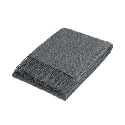 folded wool throw blanked with subtle self pattern on white back ground