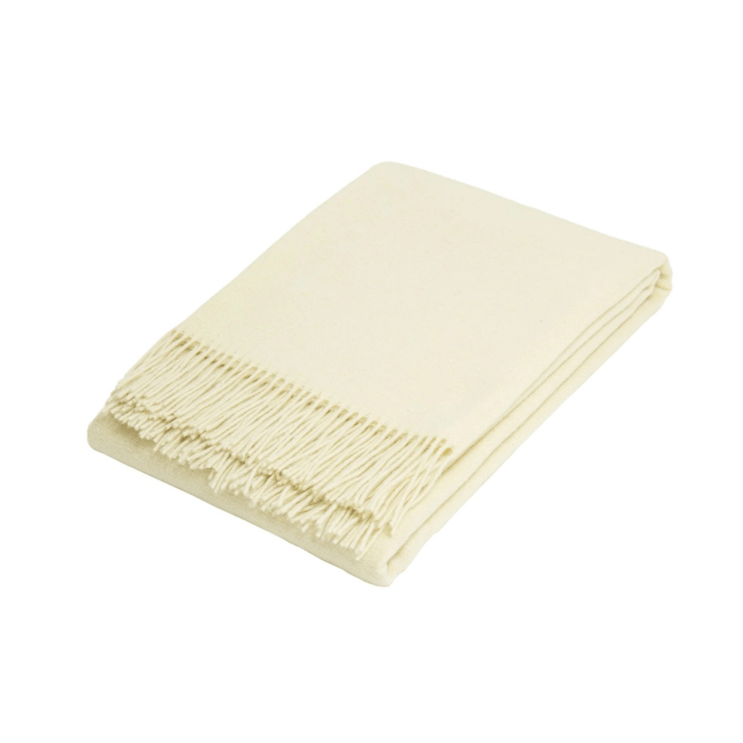 Ivory folded wool blend throw rug on white background