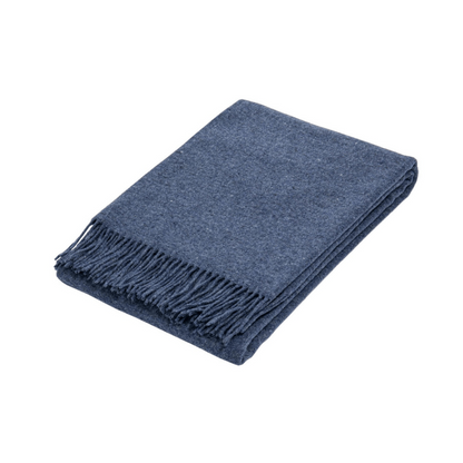 Navy blue folded wool textured throw rug on white background