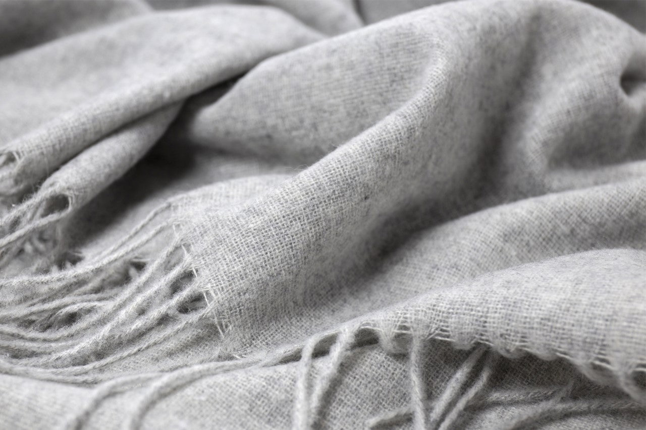 Close-up of a textured gray fabric with fringes