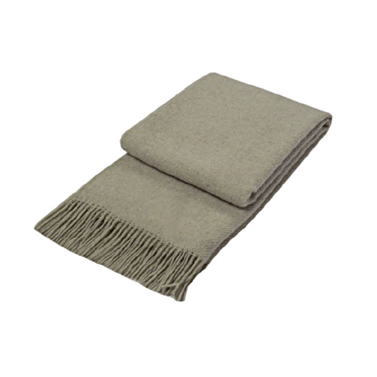 beige wool throw rug folded on white background with tassels