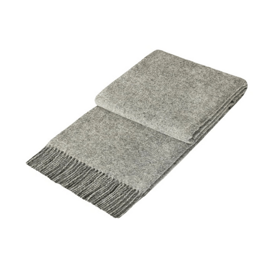 folded silvery grey wool throw rug with fringe edge detail on white background