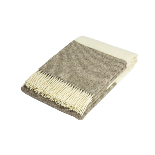 beige and cream striped wool throw rug folded and on white background