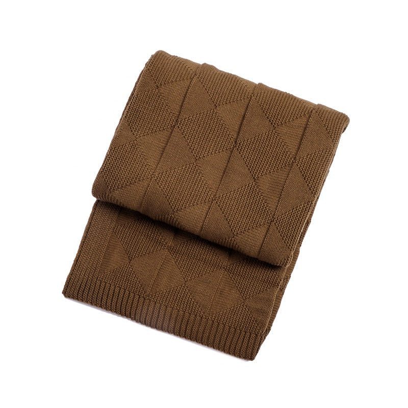 Folded brown knitted blanket on a white background