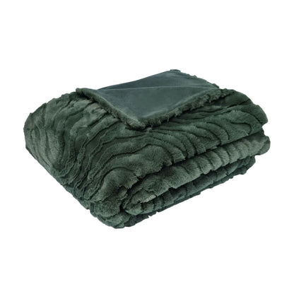 Folded green blanket on a white background | Mirra Interiors