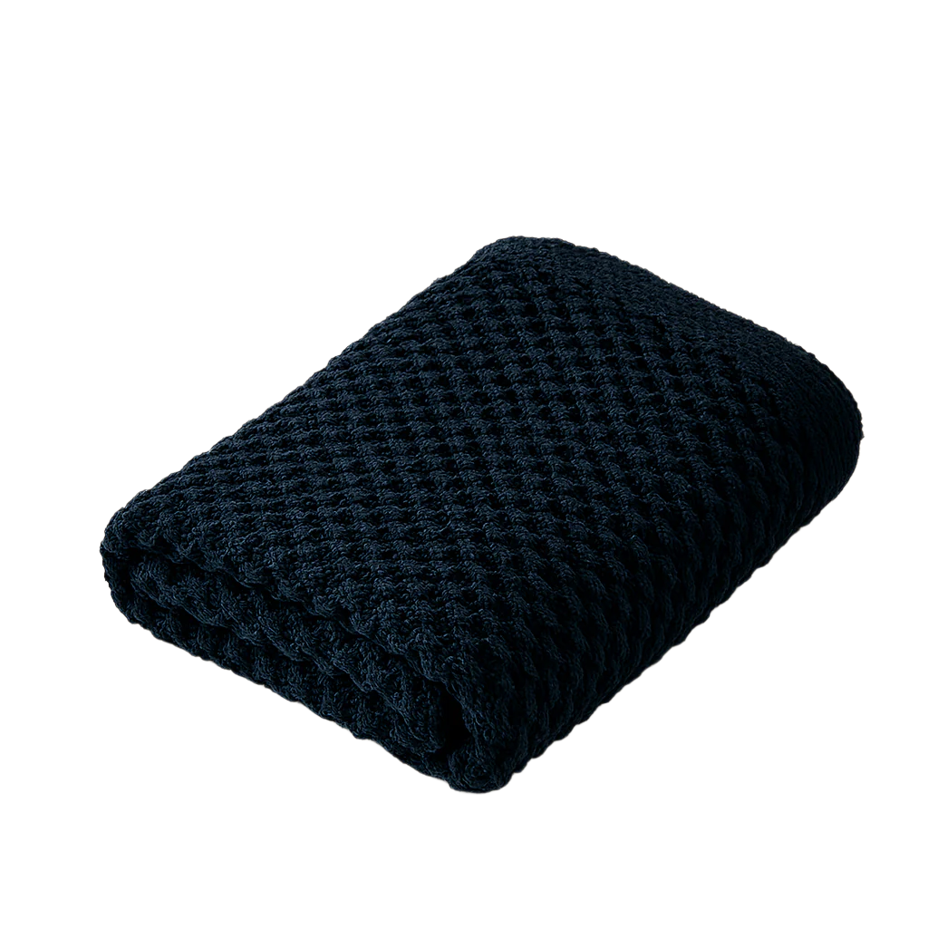 Folded navy blue textured blanket on a white background