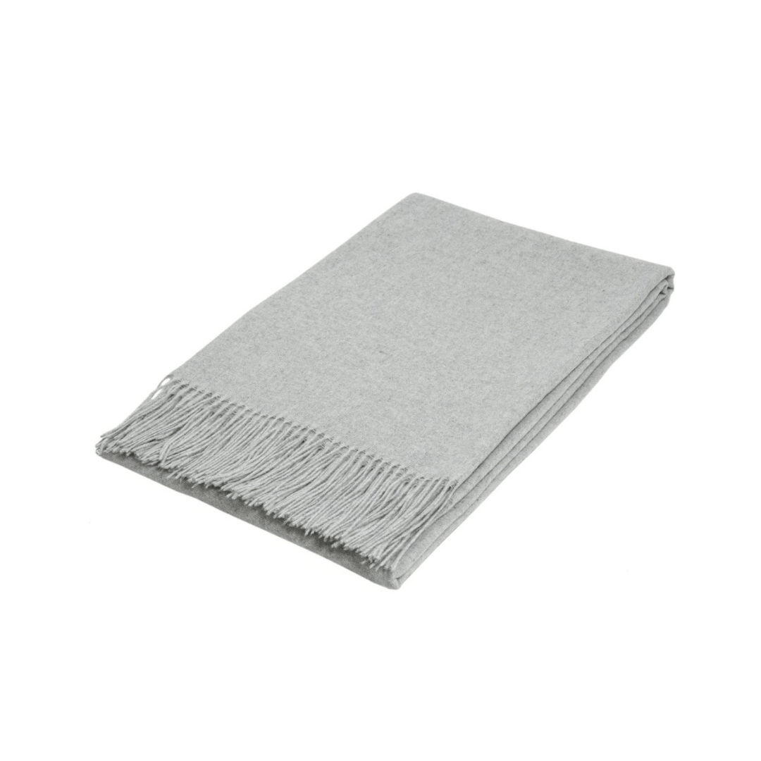 light grey silver folded wool textured throw rug on white background