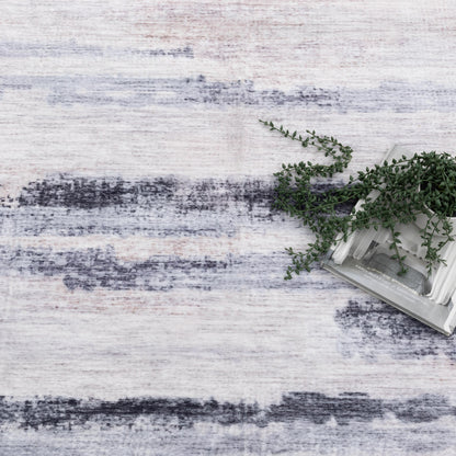 Textured white surface with a small plant in a white pot