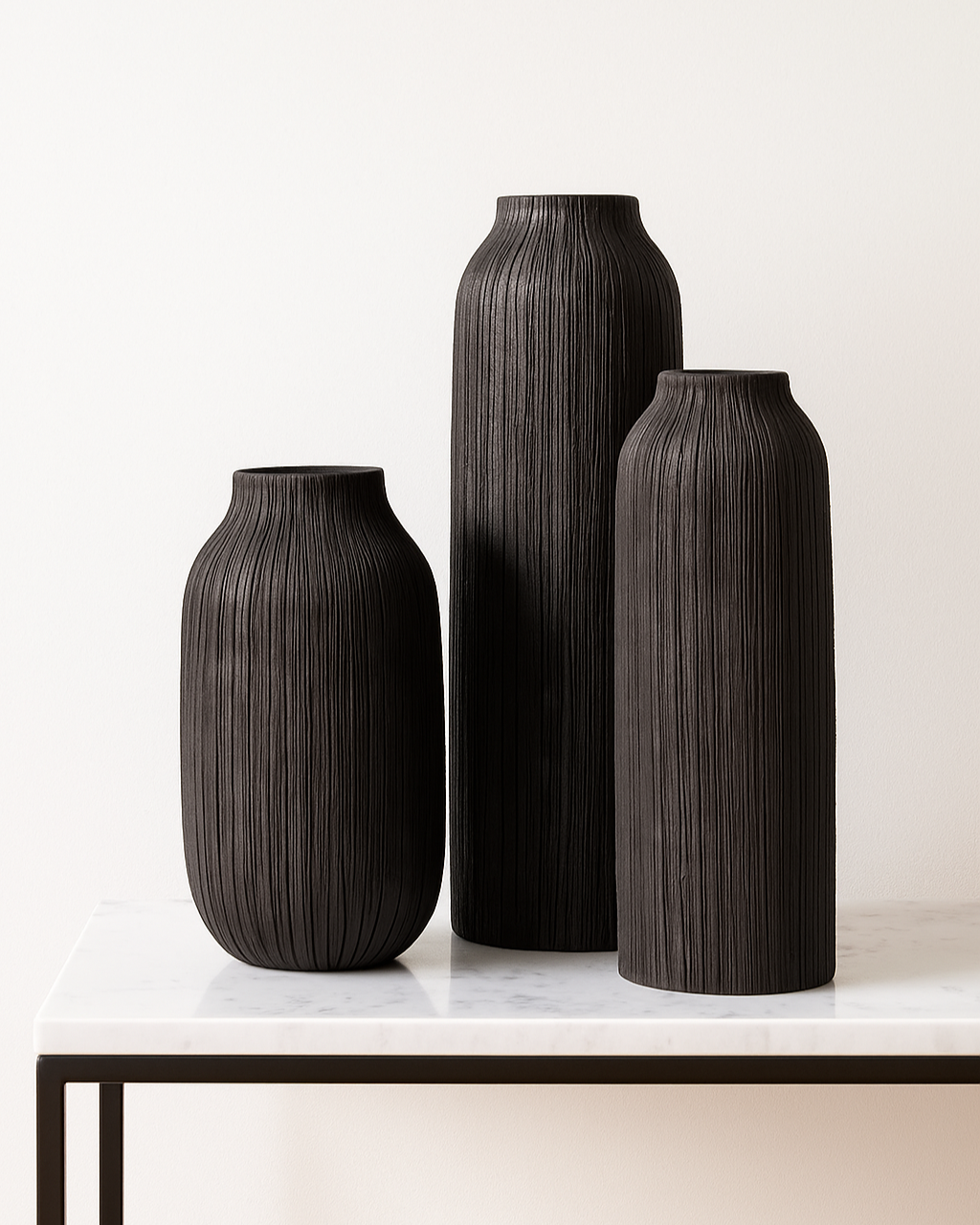 Set of 3 black rayburn vases styled on marble console table with black frame | Mirra Interiors