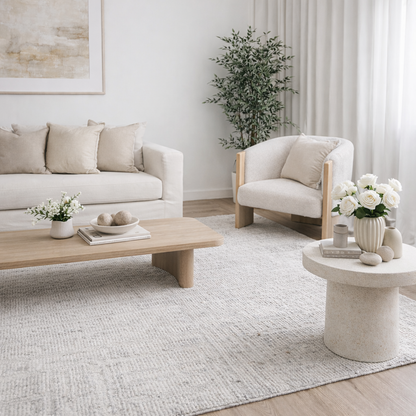 Modern living room with neutral furniture and decor showcasing a silver abstract rug 