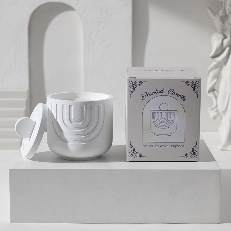 White ceramic candle holder with a matching box on a white surface