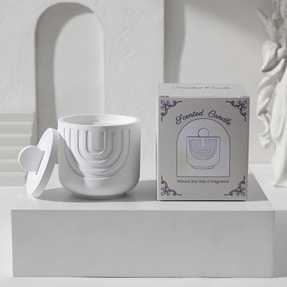 White ceramic candle holder with a matching box on a white surface