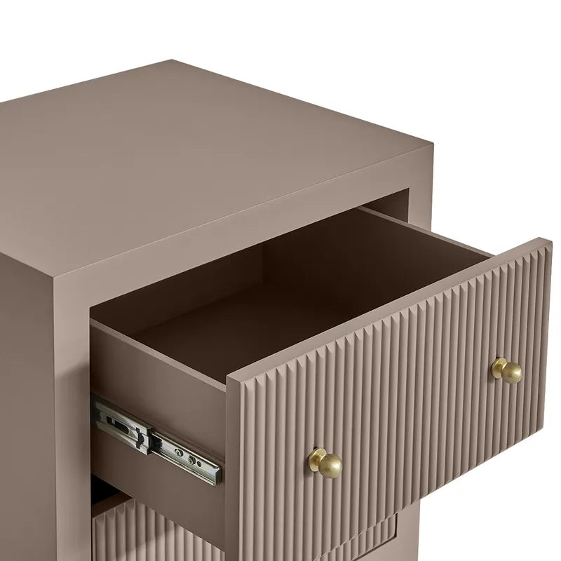 Beige side table with open drawer and gold handle on a white background