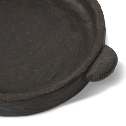 Close-up texture detail of black cement sculptural tray