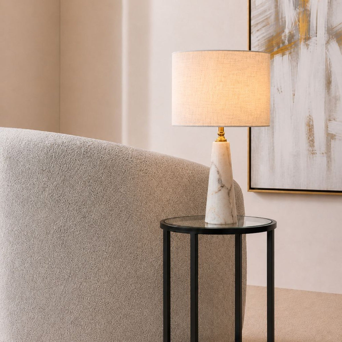 Aurelia white marble table lamp styled beside a neutral boucle sofa