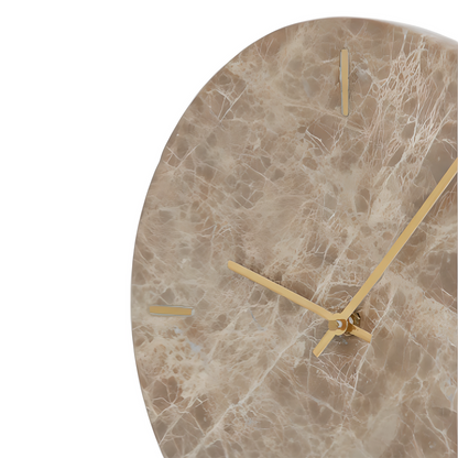 Marble-patterned wall clock with gold hands on a white background