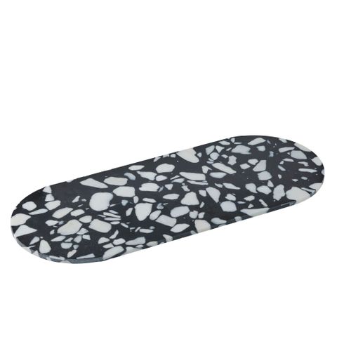 Black and white terrazzo-patterned serving board on a white background
