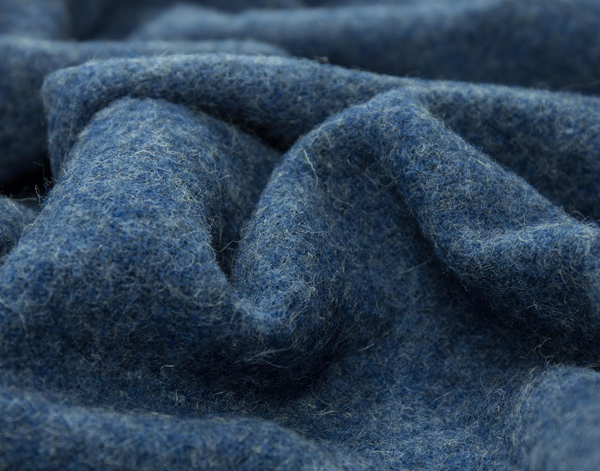 Close-up of blue throw rug with a textured wool surface