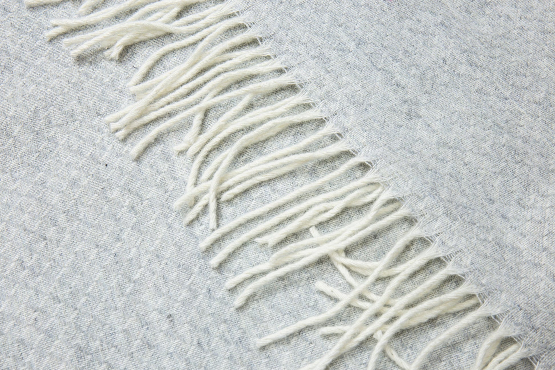 light grey wool throw blanket rug close up 
