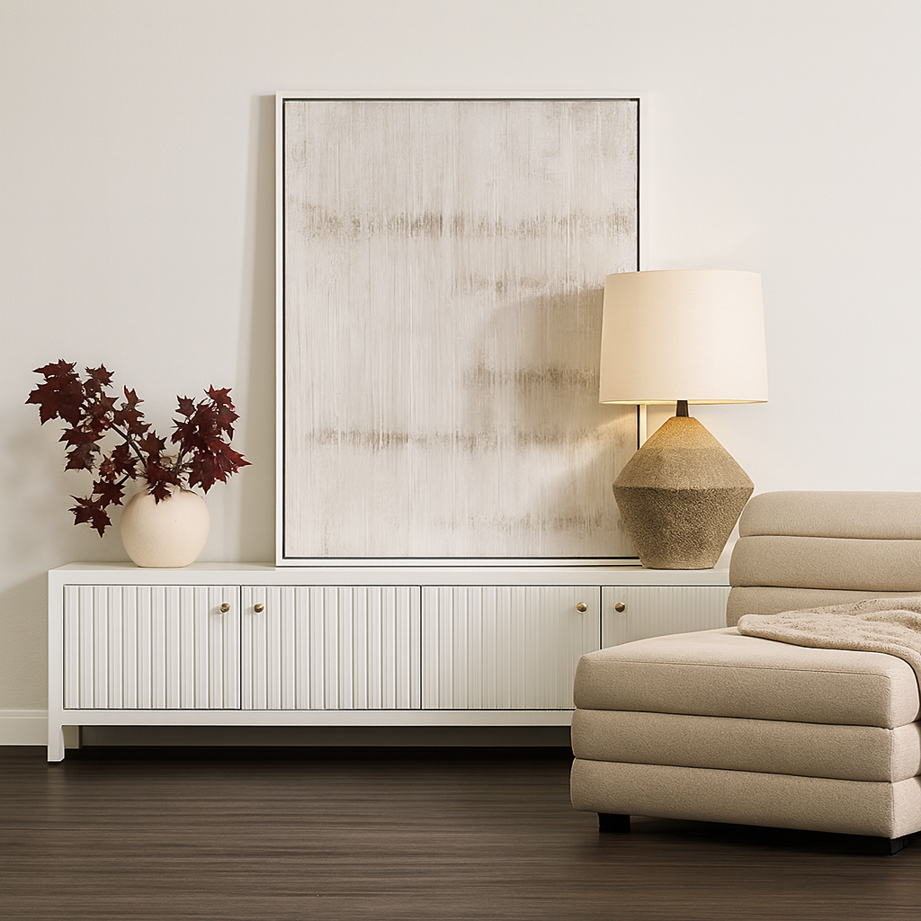Modern living room with a white cabinet, beige ottoman, and decorative lamp.