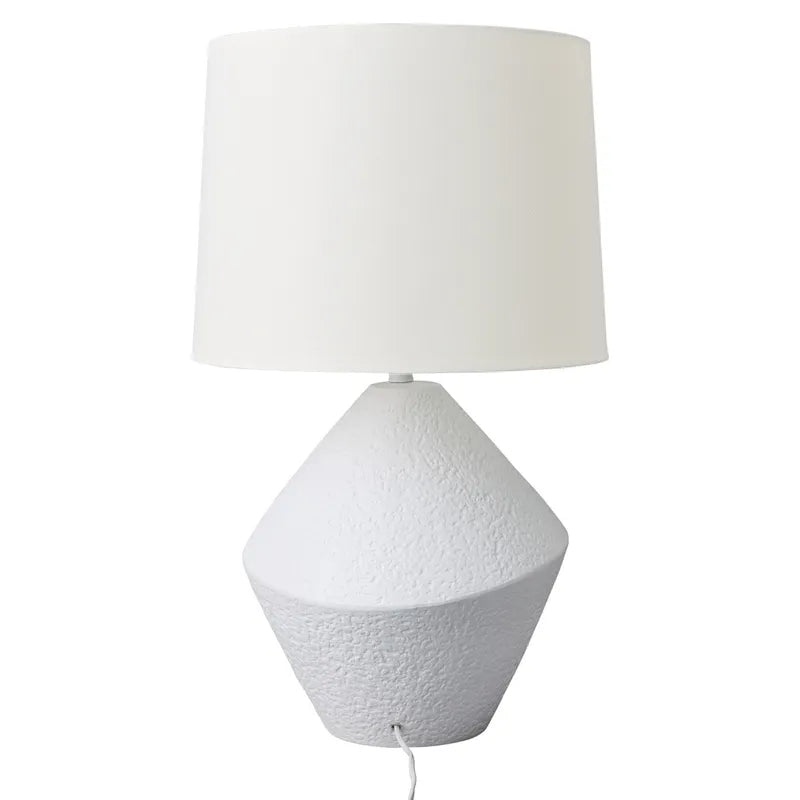 White textured table lamp with a white shade on a white background
