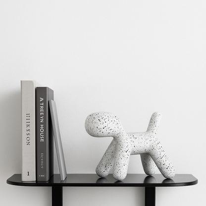 best selling white toto dog sculpture in terrazzo print styled on black shelf